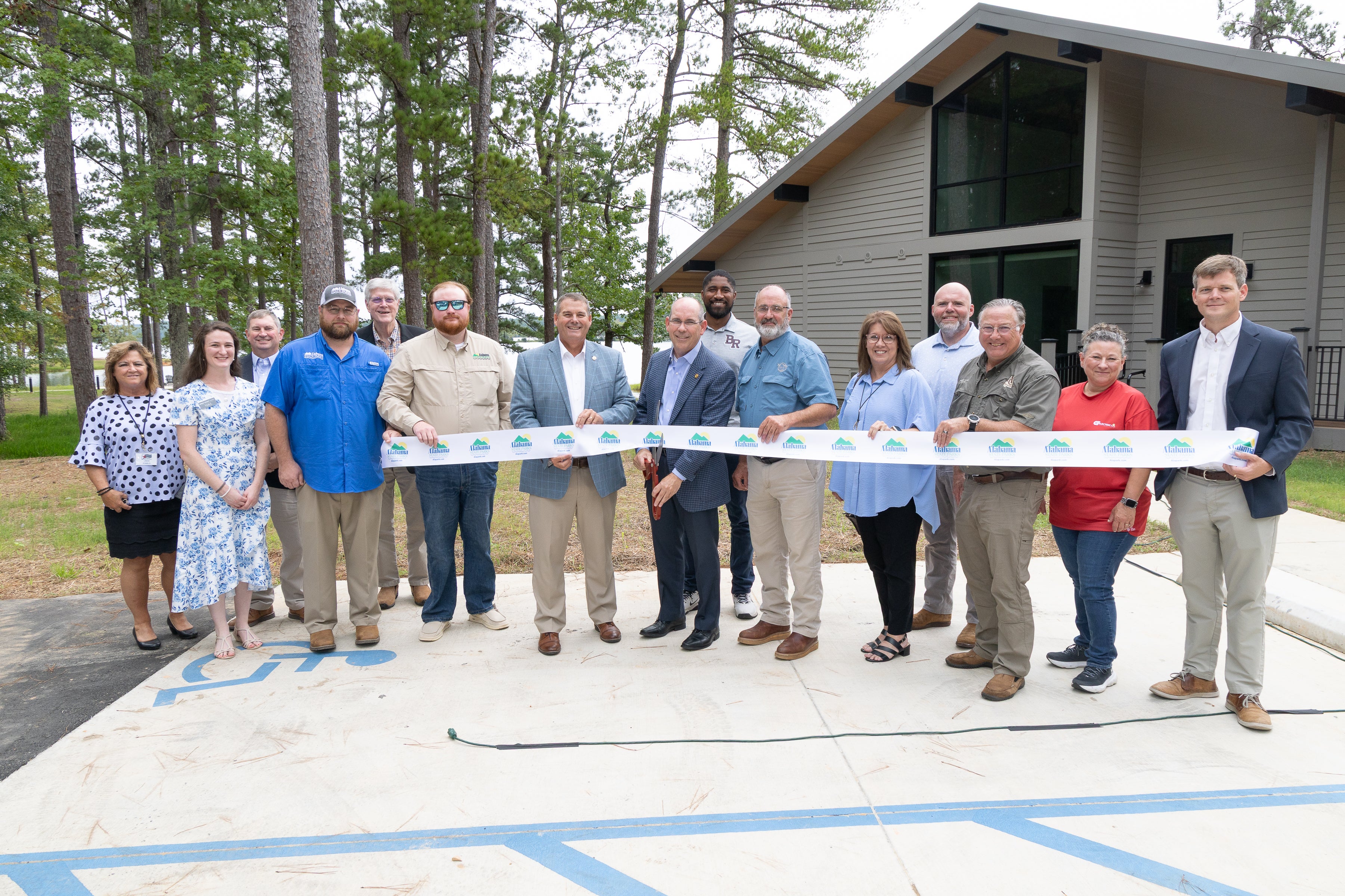 Chris Blankenship, commissioner of the Alabama Department of Conservation and Natural Resources, smiles alongside State Sen. Clyde Chambliss after the the ceremonial ribbon was cut to officially dedicate the new cottages at Wind Creek State Park on Tuesday, Aug. 5, 2025.